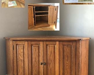 Oak corner cabinet: fold out folding doors, inner shelves; by Liberty Furniture