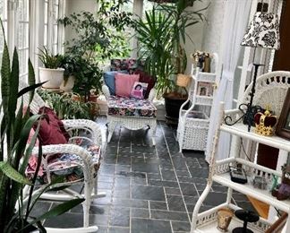 Wicker rocker, wicker lounger, two wicker shelves, wicker table, beautiful plants, pillows and smalls