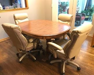 Oval, solid wood kitchen table and four Serta roller chairs (CHAIRS SOLD)