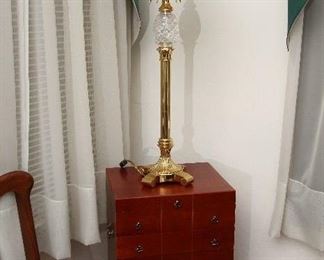 Silver chest and brass and crystal lamp with palmetto motif.