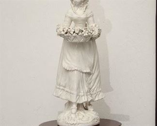 One of a pair of highly detailed porcelain figures.