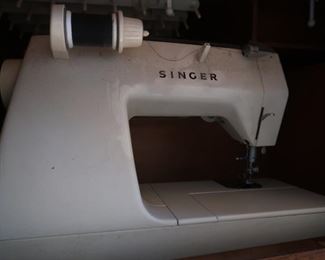 Singer sewing machine sitting in the built-in table