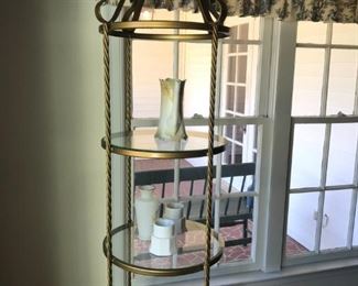 Brass and glass etagere display shelves with vintage ceramic pieces