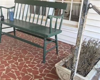 Green outdoor bench, stone planter