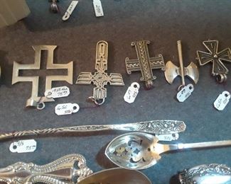 View of sterling crosses and serving pieces.