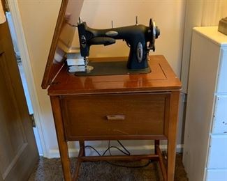 	#11	White Rotary sewing machine in cabinet	 $50.00 	 	
