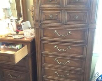 Master gentleman's chest and glimpse of the triple dresser with mirrors. Walnut.