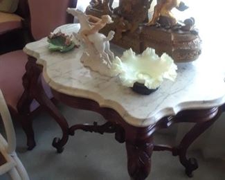 Beautiful shaped marble tops a striking table with ornate base. Large and impressive gilt bronze and porcelain clock. German figure of a nymph on white horse. is not available.