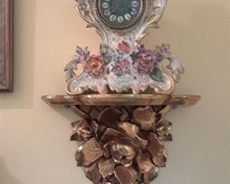 One of a pair of wall sconces in gilt wood. Good condition. Porcelain clock with applied floral design.