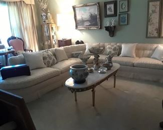 Beautiful white sectional sofa in great condition. Very elegant a la 1980s. Oval marble top coffee table in the french taste with inset medallions on the apron.