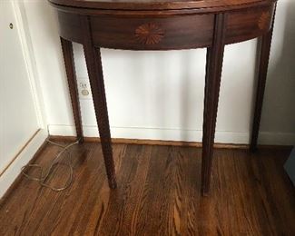 Half moon tilt top table