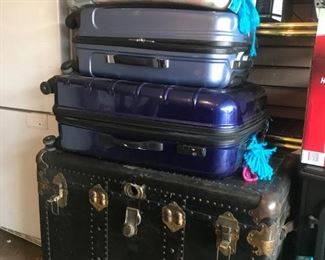 Old steamer trunk and modern luggage