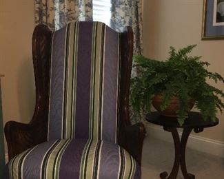 Upholstered high back armchair with case sides (pair); occasional table w/artificial plant