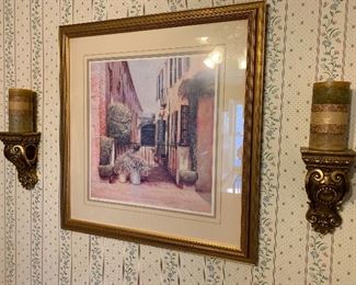 Framed numbered print with wall sconces