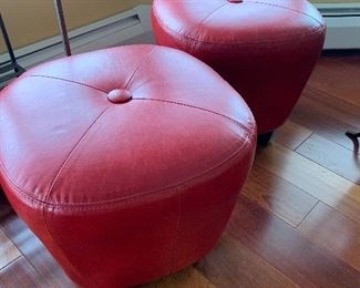 Pair of red leather ottomans