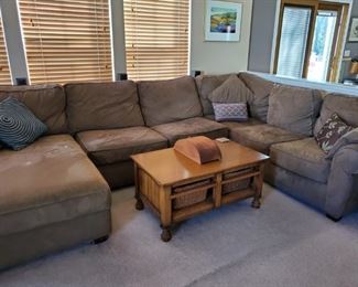Very large brown sectional. Coffee table with wicker storage baskets