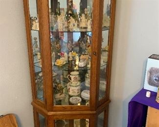 Lighted glass and mirror curio cabinet 
Snowbabies figurines