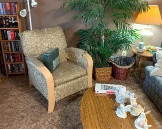 Coffee table and 2 end tables needing some tlc. Cute recliner, potted artificial plants, pole lamp, VHS tapes and shelving unit.