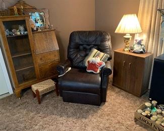 Beautiful antique secretary, brown leather lift chair, lamps, and VHS tape holder