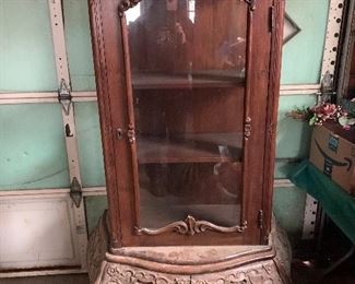 very ornately carved glass front curio cabinet