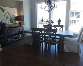 Cement table top and with four solid wood chairs and two fabric covered accent end chairs and buffet/wine rack!