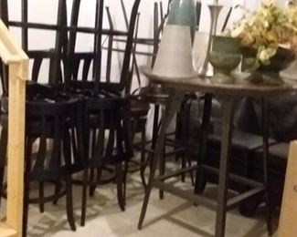 Pub height table with four stools also four bar stools.