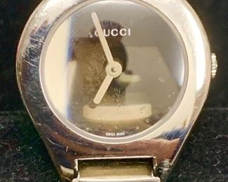 Woman Gucci watch.