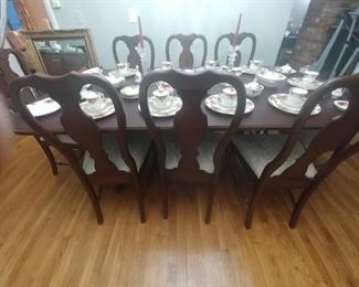 Hitchcock table with two leaves and 8 chairs two having arms