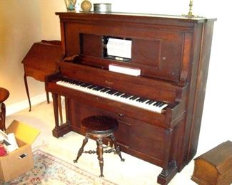 Beckwith player piano with several piano rolls, Antique piano stool.