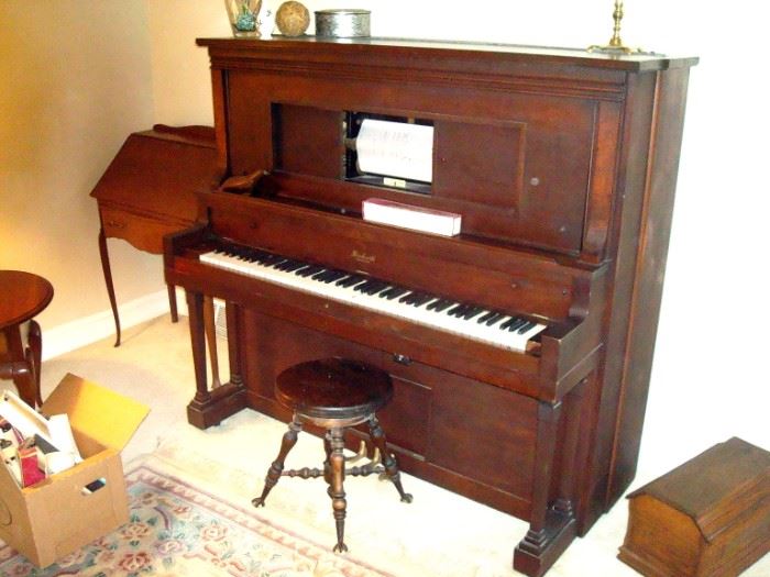Beckwith player piano with several piano rolls, Antique piano stool.