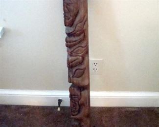 Hand carved post. Looks like part of totem pole.