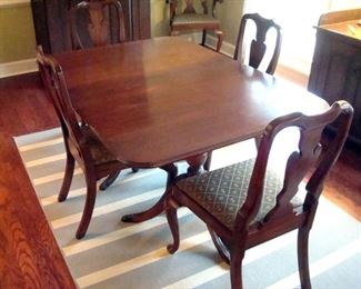 Vintage mahogany Duncan Phyfe table with two extension leaves and pads and six Henkel Harris queen Anne style chairs.