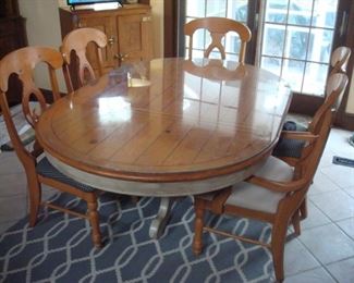 Pedestal kitchen table with six chairs.( five chairs shown). A couple of the chairs need regluing.