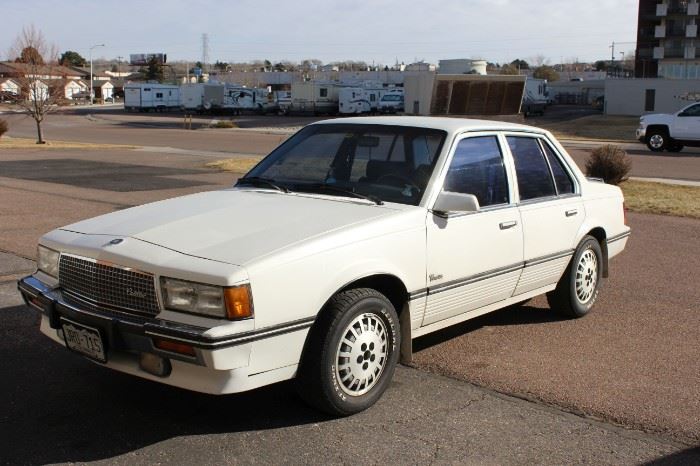 1988 Cadillac Cimarron	
White with blue leather interior, electric bucket seats in front, 1988 Cadillac Cimarron, air conditioning, cassette player, AM/FM radio, automatic transmission with 102,000 miles, power windows, needs work and possibly a new battery.
MEASUREMENTS 4 door
TESTED Yes