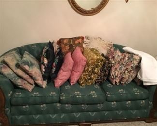 Wood trimmed upholstered sofa. Several pairs of throw pillows
