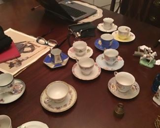 20+ porcelain cups and saucers; most with brass holders for display