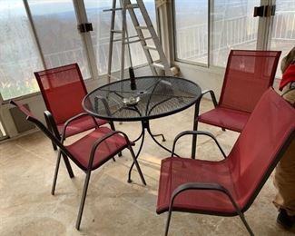 #8 4 stacking red patio chairs and round metal table $75.00