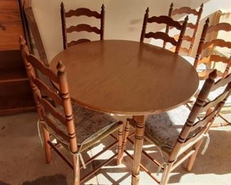 Round Maple dining table with six chairs and two leaves