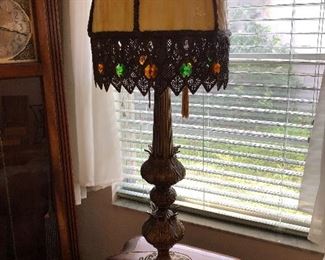 One of two slag shade table lamps