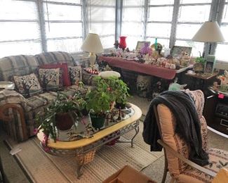 sofa, coffee table, plants, lamps, decorative pillows