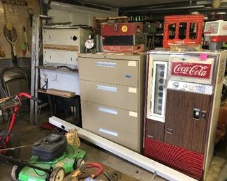 Coca-Cola vending machine, lateral file cabinet, push mower, Coca-Cola crates