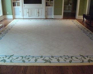 Family Room:  The cream color wool rug has a subtle garland trellis field with a yellow tip-sheared border and floral border in green vine/blue/yellow  (see next photo for closer view).  It measures 12'  9"  x 15.' The pad is included.