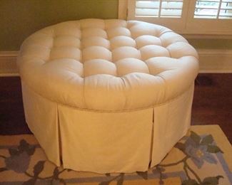 Master Bedroom-First Floor: A solid ivory color ottoman with contrast button top and cording was custom made. 