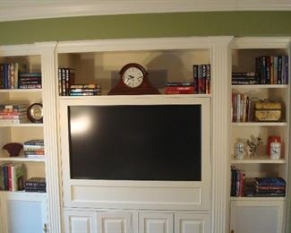 Family Room Bookcase:  The built-in bookcase displays books, a mantel clock by HOWARD MILLER (a closer photo follows), and other décor.