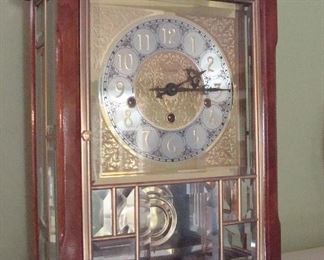 Family Room-Mantel:  This is a closer photo of the ANSONIA "Gold Medallion" clock which has a brass handle, brass engraved face, pendulum, and four brass feet.  The glass door is multi-pane. (The key will be with the cashier.)