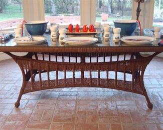 Sun Room:  A very nice rectangular glass top/wicker table (42" x 82") has an umbrella hole in the center.  Nearby is a tan canvas umbrella that is priced separately. The next photo shows the table all set for  a seafood feast. 
