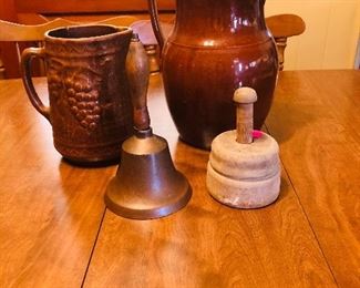 School bell, butter mold, brown stoneware pitcher and vintage North Star pottery pitcher