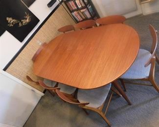 Mid-century dining table has 8 chairs 
