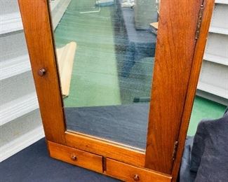 early wooden medicine cabinet with mirrored center 