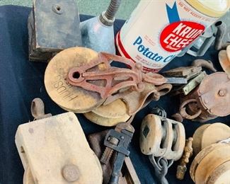 several fancy wooden and cast iron barn pulleys 